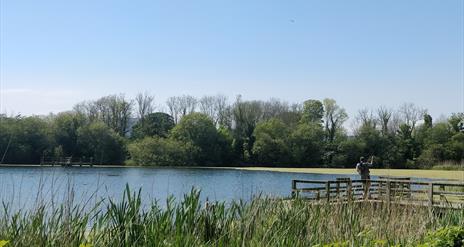 A fisherman casting his fishing line at Donaghaguy Waterworks.
