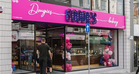 Exterior of Dougies Goodies Bakery in Ballymena with pink and purple signage