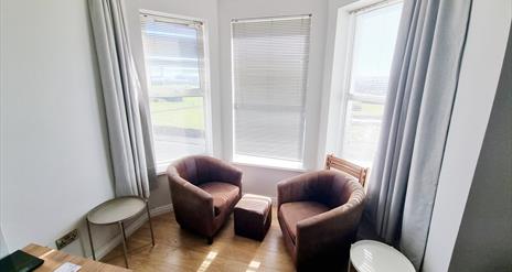 Table and chairs seating area by window