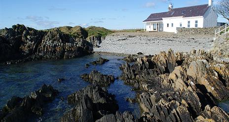 Back exterior with beach and rockshore