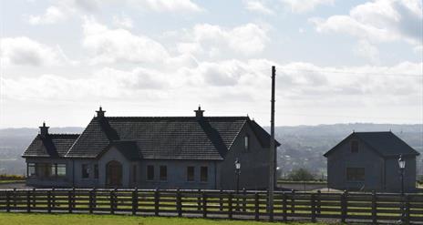 Image of a Bungalow and garage from across a field