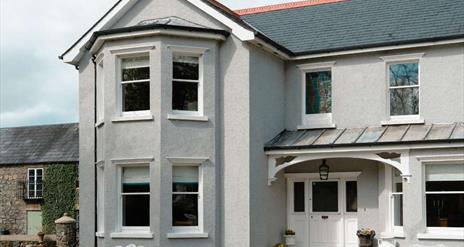 Front of large detached house with courtyard in background