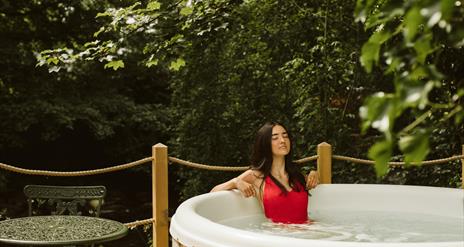 Galgorm Riverside Cottage with outdoor hot tub overlooking the river