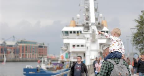 Crowds gather along Queens Quay in Belfast to enjoy Belfast Maritime Festival.