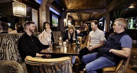 A group of friends sitting around table at Hagen's Bar