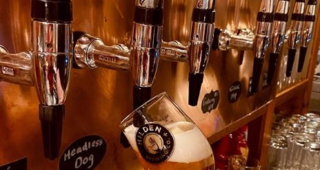 Image is of a beer being pulled on tap at Hilden Brewery