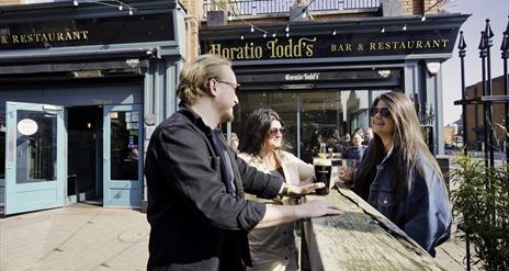 Group sitting outside Horatio Todd's having a drink and chatting