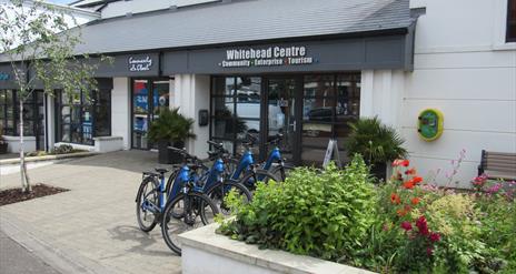 Photograph of Whitehead Centre with e-bikes display in a row.
