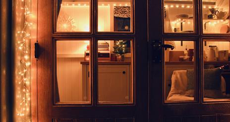 Peatlands shepherd hut doors with festive decoration.