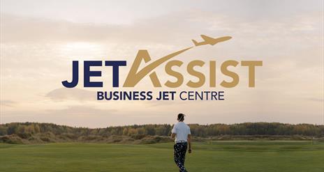 Jet Assist Logo on golf course background with person holding golf club