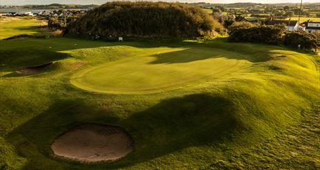 Silhouettes of golfers on the green