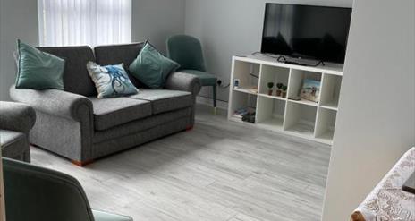 interior of living area at Garden Avenue 2 featuring TV and sofa