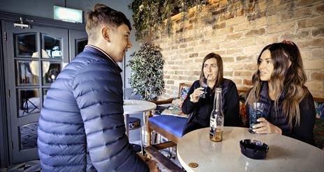 Group of friends at in garden area McAleers Bar