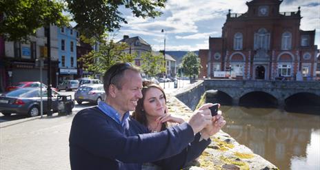 Couple taking a selfie (at Newry Town Hall) enjoying themselves on The Story of Newry Walking Tour.
