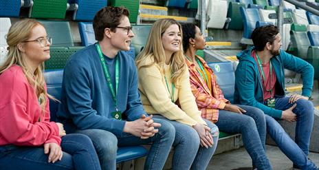 Group in the football stands enjoying a behind the scenes guided tour of Windsor Park with the Irish Football Association