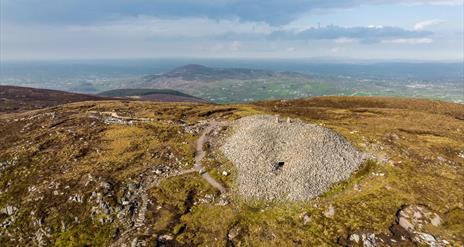 Birds eye view showing Slieve Gullion Cairn from top and surrounding landscape in the background.
