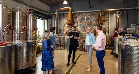 Tour group admire the stills within the Copeland Distillery