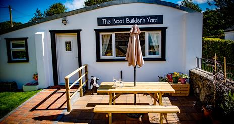 The Boat Builder’s Yard, Portaferry with Summer table and bench outside.