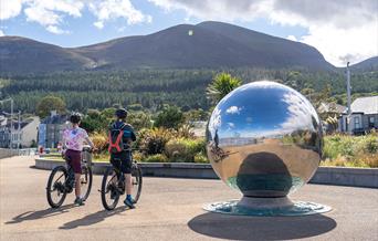 Cyclists on bikes from Bike Mourne, Newcastle admiring the Mourne Mountains from the Promenade, Newcastle, County Down