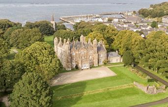 Aerial view of Glenarm Castle & Gardens with the ocean beyond.