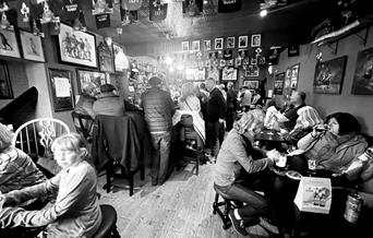Bar with people drinking at tables