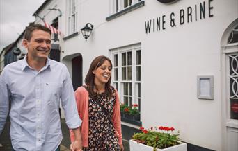 Couple walking outside the Wine & Brine restaurant