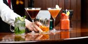 A bartender serving a selection of different drinks.