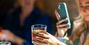 Girl taking photo at Belfast Whiskey Week