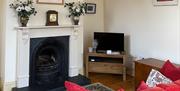View of livingroom with TV, fireplace and sofa