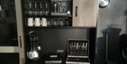 The kitchenette area comprises of a small air fryer oven, kettle, toaster, 2 rings for saucepans. A fridge and freezer.