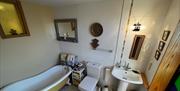 bathroom equipped with a claw foot cast iron bath.