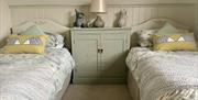 Photo of the upstairs twin bedroom with  two single beds