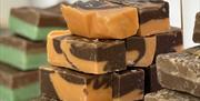 Colourful fudge wedges stacked on display.