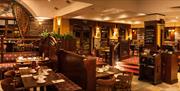 A large restaurant dining area with multiple sections filled with set tables.