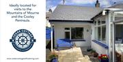 A view of the exterior of Cedar Cottage. A white cottage with blue accents.