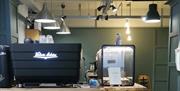 sign on a cafe counter reads 'Welcome to INFUSE'