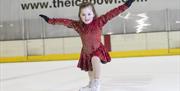 Image is of young girl skating alone