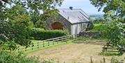 Exterior of Mill Cottage from a distance showing surrounding fields