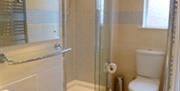 An en-suite bathroom with a walk-in shower and a toilet.