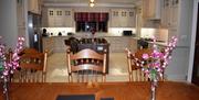 Image of the large kitchen from the dining table