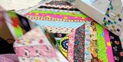 Sewing machine and patchwork quilt in progress at Midtown Makers workshop