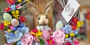 easter floral wreath, with rattan rabbit in the centre