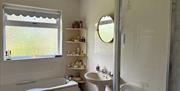Bathroom with bath and shower.