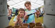 Two young boys take part in planting activities in the horticulture area