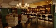 Cosy bar with plush furnisings and a long bar stocked with local spirits and whiskies.