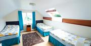 Upstairs bedroom with 3 single beds