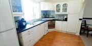Kitchen with oven, dish washer and electic hob