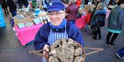 The Oyster Catcher showing off his locally caught oysters at Inns Cross Market.