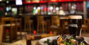 Bowl of mussels and a pint of Guinness