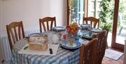 Dining table set for tea in kitchen diner